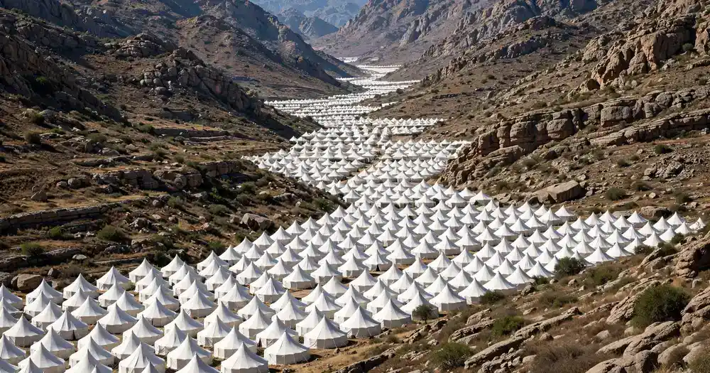 White tents filling the valley of Mina beneath the mountains during the pilgrimage days