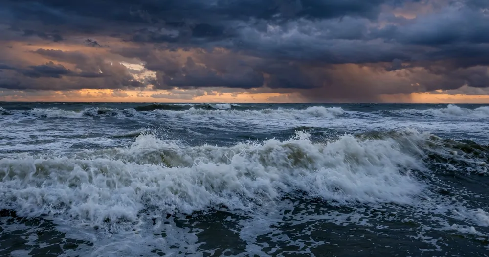Ocean waves under a dramatic sky, among the blessings the surah lists